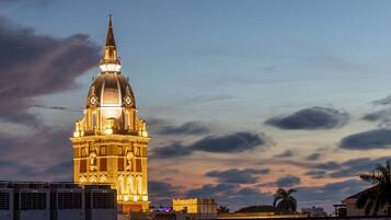 A historic building with a prominent dome and spire, surrounded by modern structures.