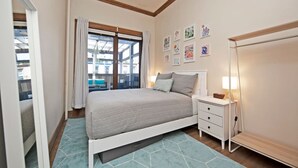 A bedroom with a bed, nightstand, lamp, and artwork on the wall. - Centralized apt in Park Slope near the park and the city (Brooklyn)