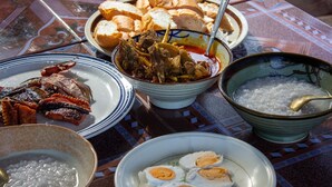 A table with various dishes including meat, eggs, and a bowl of rice. - Sabay Farm (Kampot)