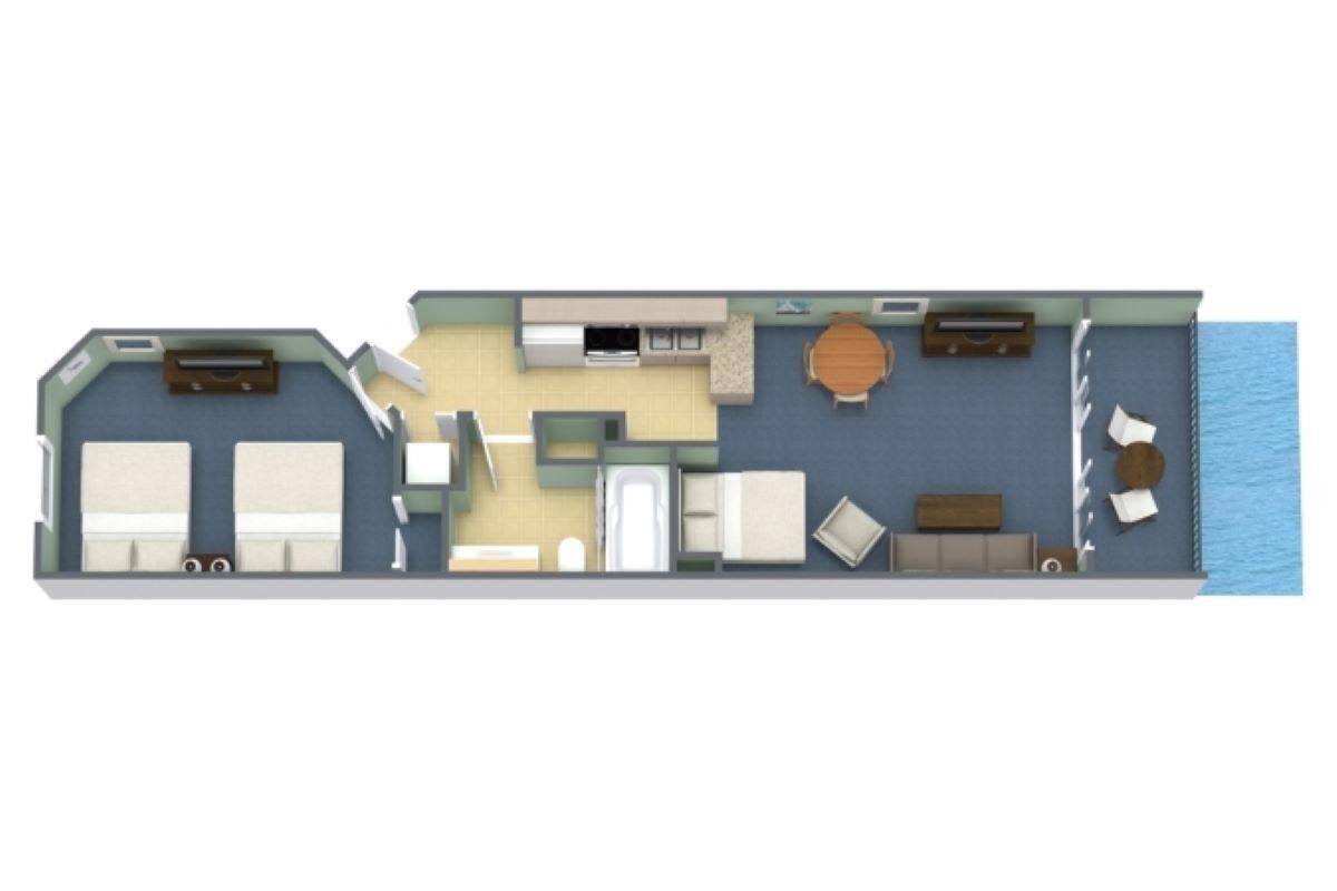 Planta baixa de um quarto de hotel com uma cama, uma escrivaninha, uma cadeira, uma pequena cozinha e vista para o mar.