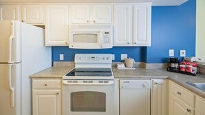 A compact kitchen with white cabinets, a microwave, stove, oven, and dishwasher. - Amazing Views from 19th Floor! Sleeps 8 (Myrtle Beach)