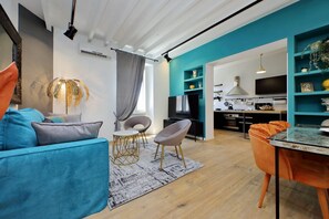 A modern living room with a sofa, chairs, a coffee table, and a dining area with a table and chairs. - Amazing penthouse in the heart of Rome (Roma)