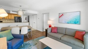 A modern apartment with a dining area, kitchen, and living room. - Newly Renovated Ocean View 2 Bdrm Condo 8th Flr (Myrtle Beach)