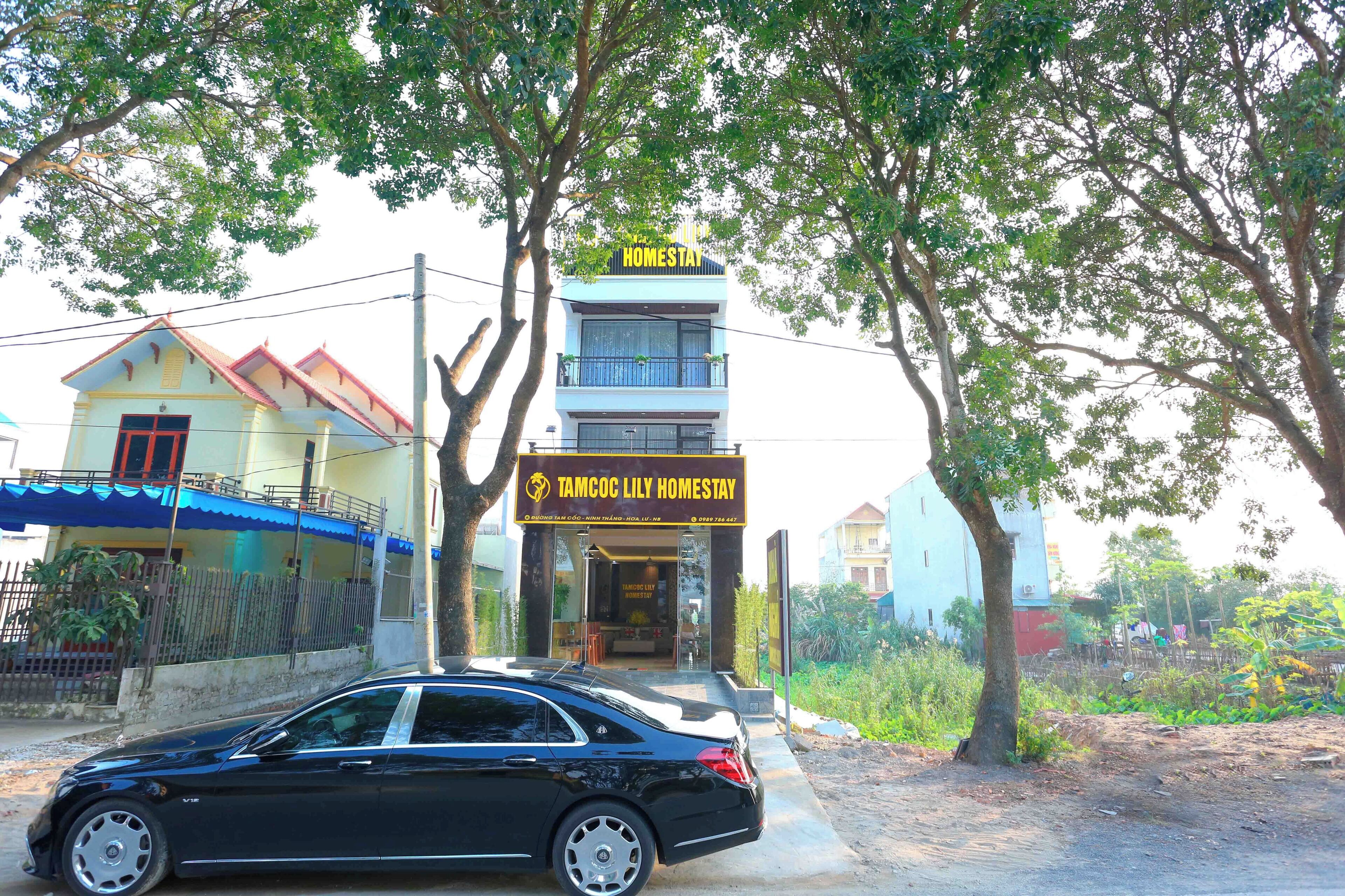 A two-story building with a sign reading "TAMCOC LILY HOMESTAY".