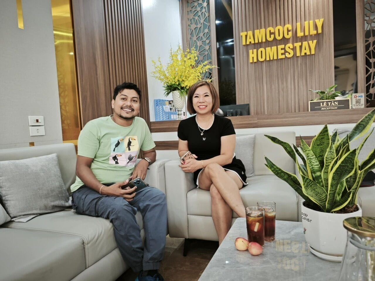 A reception area with a sign reading "TAMCOC LILY HOMESTAY".