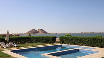 Relax by the pool surrounded by lush hedges and take in the breathtaking views of the distant mountains.
