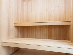 A wooden interior with two horizontal wooden shelves.