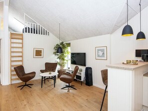 A modern living space with a dining area, a kitchen, a TV, and a staircase. - 5 Star Holiday Home in Romo (Rømø)