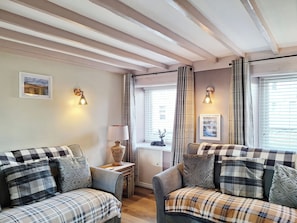 A cozy room with two sofas, a lamp, and a window with curtains. - 2 bedroom accommodation in Ingleton (Ingleton)