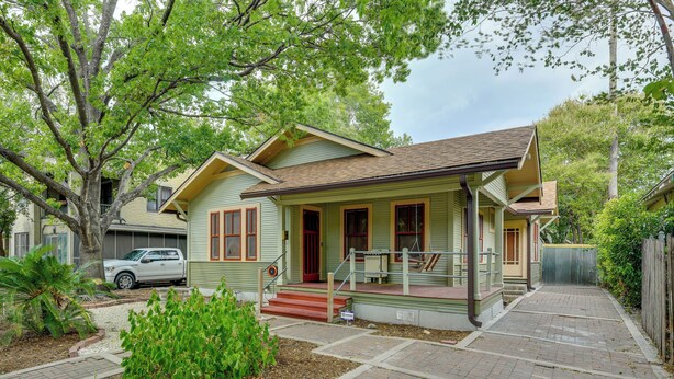 A two-story house with a front porch, a garage, and a driveway. - San Antonio Gem in Prime Location w/ Outdoor Space (San Antonio)