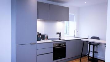 Apartment, 1 King Bed | Private kitchen | Fridge, microwave, oven, stovetop