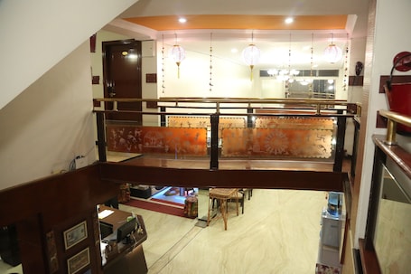 A staircase with a wooden handrail leading to a lower level.