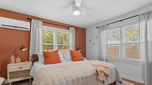 A bedroom with a bed, nightstand, and window with blinds. - Mid-City Bungalow, 1 Mile from Bathhouse Row, Pup Friendly, Fully Fenced Yard! (Hot Springs)