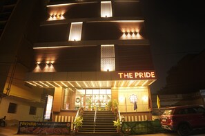 A building with a sign reading "THE PRIDE" and a banner for "PAKWAN PURE VEG FAMILY RESTAURANT". - The Pride (Golmuri)