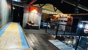 A wooden bench with a blue edge, a cushioned seating area, and a staircase leading to a higher level. - New Rustic Retreat, Firepit & Games, Hiking, Boating & Fishing near Lake Rathbun (Moravia)