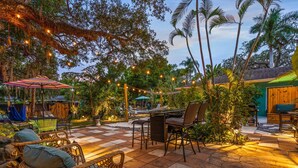 A patio area with outdoor furniture, a hammock, and string lights. - Salty Lime Villa 2-Riverview w/pool on riverwalk, near AMI beaches, pet friendly (Bradenton)