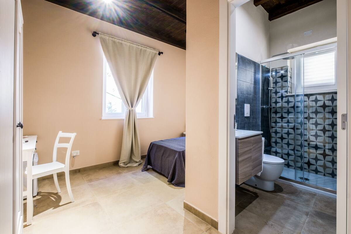 A bathroom with a shower, toilet, and sink.
