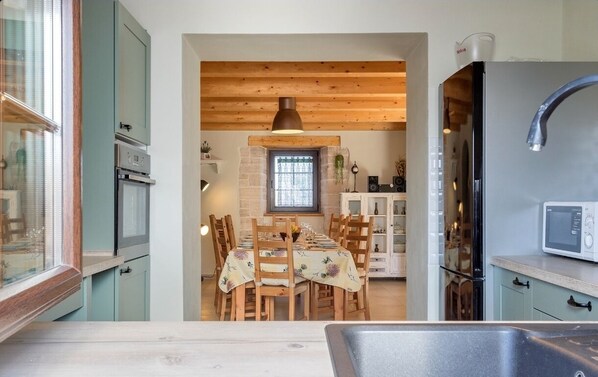 Enjoy meals in this cozy kitchen with an oven, microwave, and dining table for four.