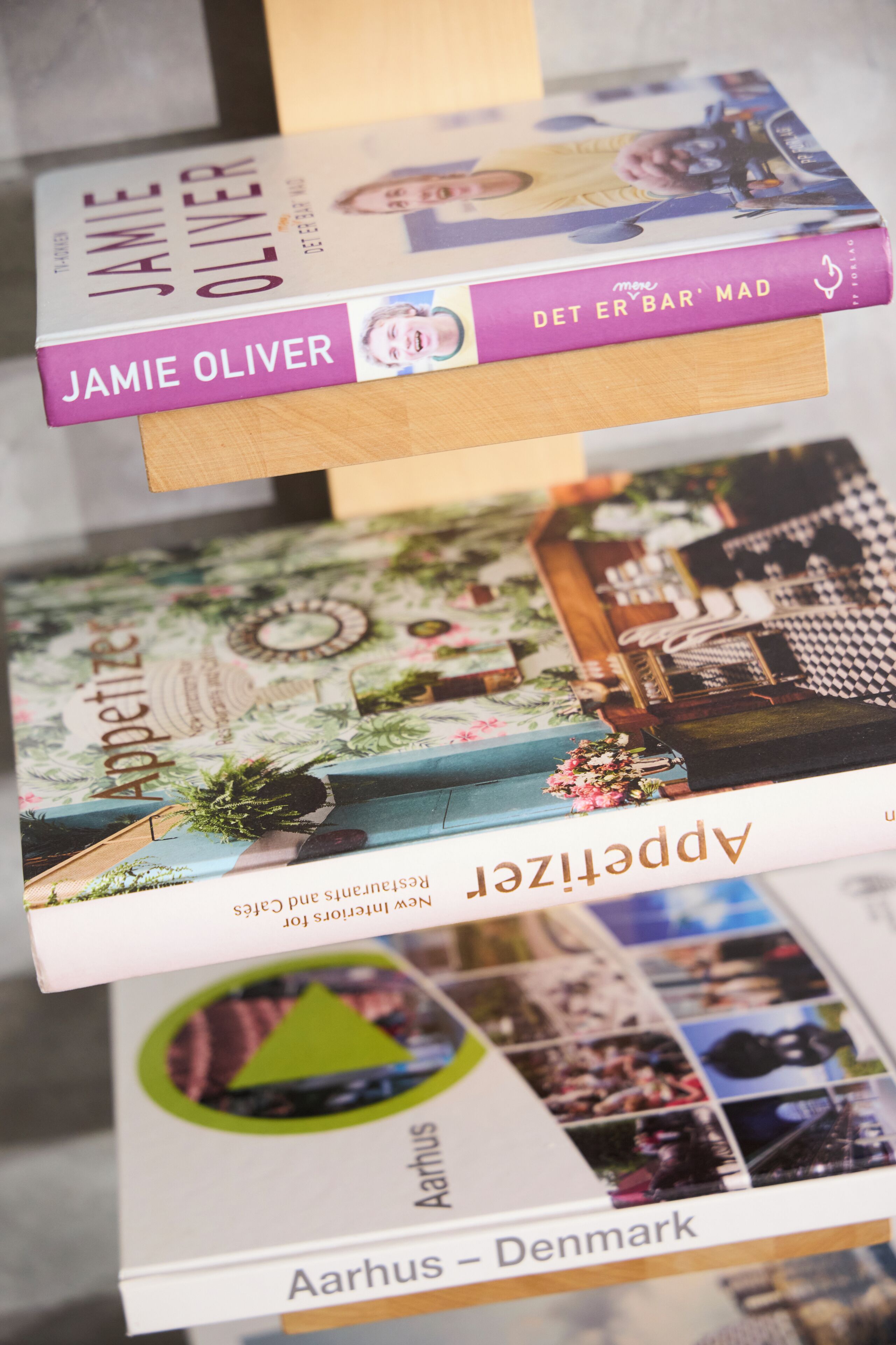 A stack of books with visible titles and authors.