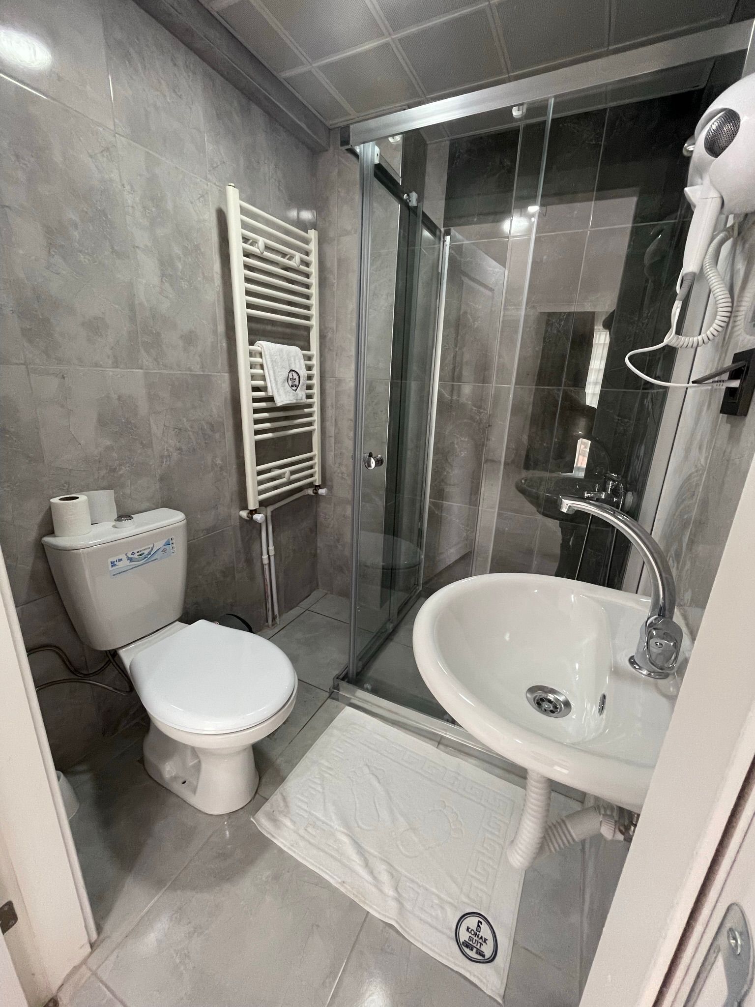 Shower, rainfall showerhead, hair dryer, towels