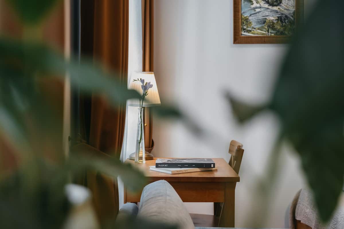 A room with a wooden table, a lamp, and a book titled 'Passport'.