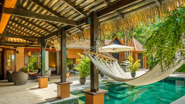 A pool area with a hammock, lounge chairs, and potted plants. - Experience the Pure Life in the Private Jungle Paradise of Ojochal  (Provincia de Puntarenas)