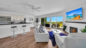 A modern living room with a white sofa, a coffee table, and a fireplace. - • Book HARBOR VIEW • Luxury 3BR • Panoramic Ocean & Harbor Views (Dana Point)