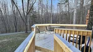 A wooden deck with a railing, surrounded by trees. - Cozy Cabin Natural Bridge VA (Natural Bridge Station)