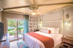 Relax in this serene space with a large bed, ceiling fan, and sliding glass door offering a view of the outdoors.