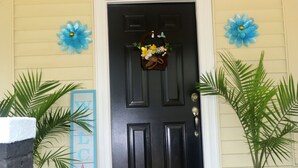 A black door with a welcome mat, a blue 'WELCOME' sign, and two blue flower decorations. - Beautiful contemporary 2BDR - Concord (Concord)