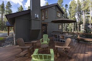 A wooden deck with Adirondack chairs and a table, overlooking a forested area. - Ski Hill Ridge on Peak 7 with Epic Views! (Breckenridge)