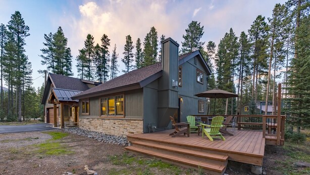 A cabin with a stone foundation, wooden deck, and outdoor seating area. - Ski Hill Ridge on Peak 7 with Epic Views! (Breckenridge)
