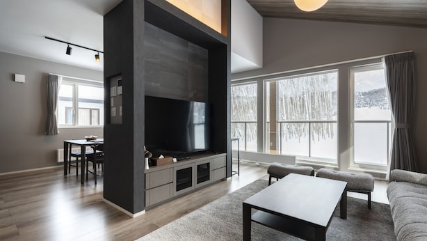 A modern living room with a large flat-screen TV, a dining area with a table and chairs, and a sofa. - CONTRAIL【Ezo Fuji hoothills】 (Makkari-mura)