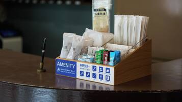 A hotel reception desk with a sign indicating amenities.