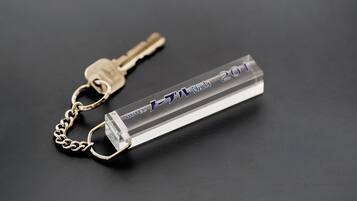 A keychain with a transparent plastic tag and a metal key attached.