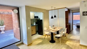 A modern kitchen with a microwave, refrigerator, and white cabinets. - Apartamento,5 Parque de la 93 (Bogotá)