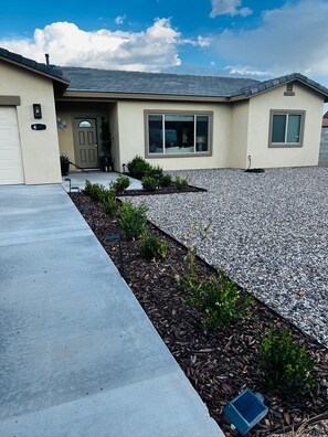 A residential house with a driveway, a front door, and a small garden area. - Bright Star - Hot Tub • Near Sedona & Old Town (Cottonwood)