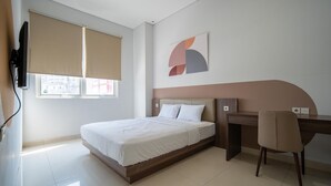 A modern hotel room with a bed, a desk, and a chair. - Cove Senja (Jakarta)