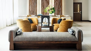 A modern living room with a sofa, armchairs, and a coffee table. - AC Hotel by Marriott Honolulu (Honolulu)