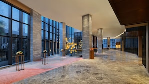 A spacious lobby with large windows, marble flooring, and modern decor. - Sheraton Kuching Hotel (Kuching)