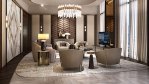 A modern hotel lobby with a large chandelier, comfortable seating, a television, and a view of the city. - Sheraton Kuching Hotel (Kuching)