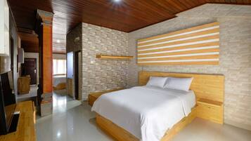 A modern bedroom with a wooden bed, a stone wall, and a wooden ceiling.