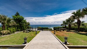A pathway leading to a body of water with a view of the ocean. - Seaview Villa Coastal Estate (Shoufeng)