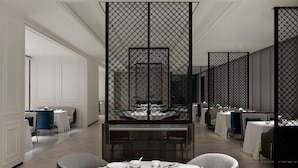 A modern dining area with a central table set for a meal, surrounded by high-backed chairs. - Tonino Lamborghini Rosso HangZhou (Suzhou)