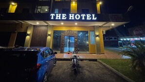 A hotel entrance with a sign reading "THE HOTEL" and a motorcycle parked in front. - THE HOTEL (Sandakan)