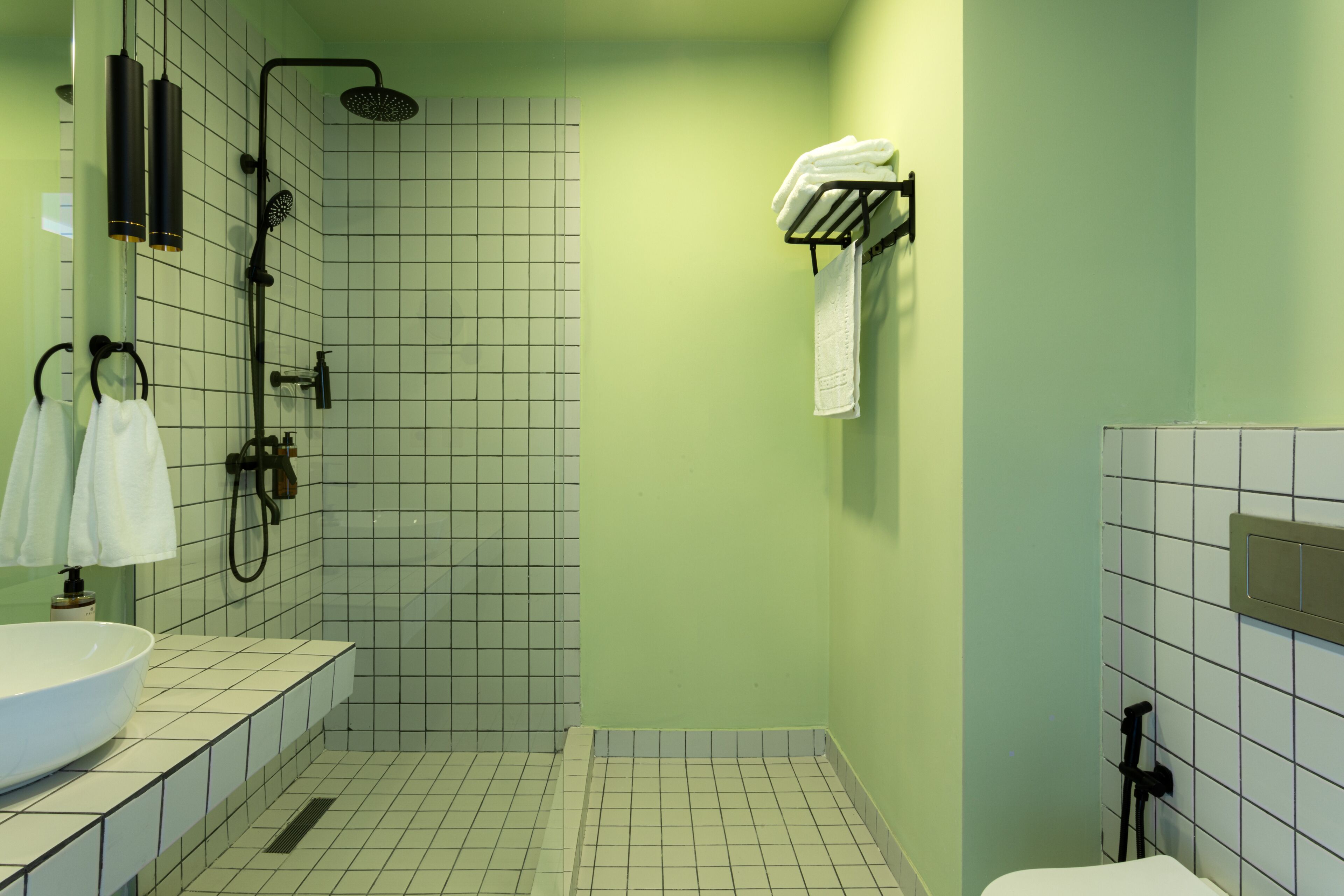 A bathroom with a shower, a sink, and a toilet.