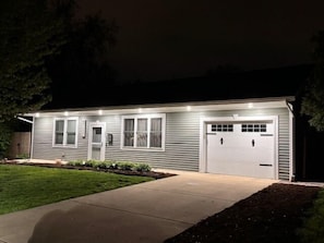 A single-story house with a garage, a front door, and a small porch area. - Central location | Hot Tub | Heated Pool | Digital Game Table (Normal)