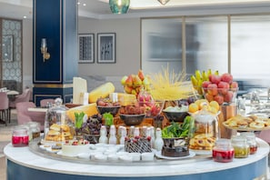 A buffet with various food items and condiments. - Radisson Collection Hotel & Spa, Riverfront Srinagar (Srinagar)