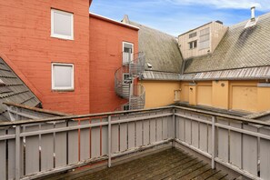 A multi-story building with a metal staircase connecting the floors. - Amalie Apartments By First (Tromsø)