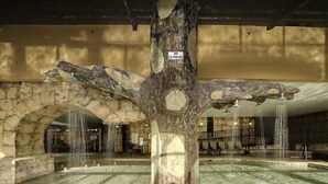 A large tree sculpture with a 'No Climbing' sign, surrounded by a reflective pool and stone arches. - 🌴Stunning Ocean Views | Pools + Hot Tub | The Island 1214🌴 (Myrtle Beach)